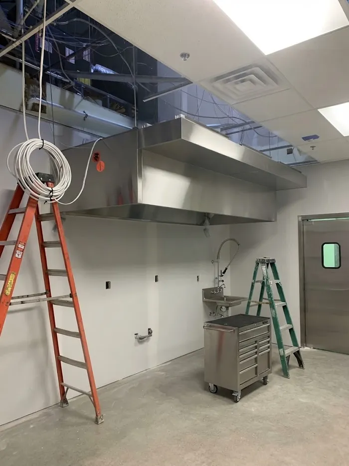 New commercial kitchen exhaust hood installed during a restaurant buildout