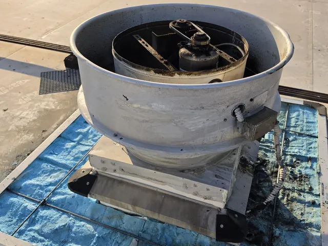 Rooftop commercial kitchen exhaust fan before cleaning